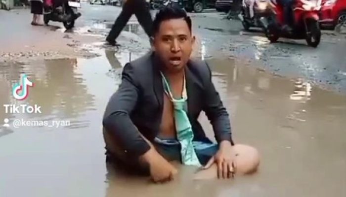 Pria di Palembang Protes Jalan Rusak dengan Mandi Air Kubangan